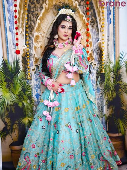 The full-length shot captures the flowing lehenga and the overall grace of the Radha character.