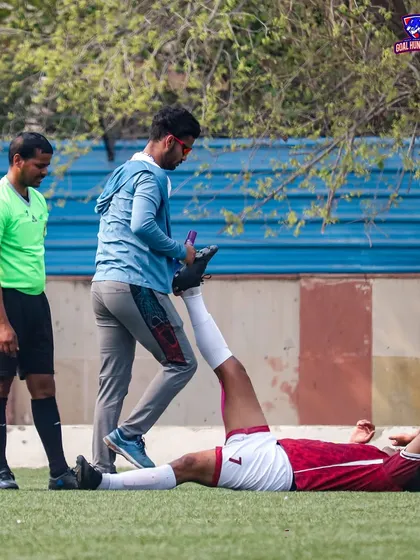 A player receiving stretching assistance from our support staff to prevent injuries.