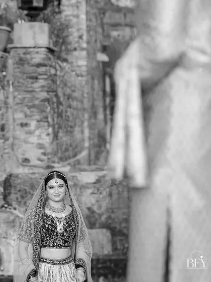 A black and white version of image 168, a bride looking towards the groom.