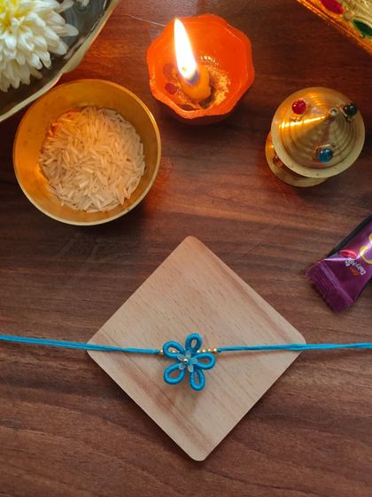 A lovely blue floral rakhi made with thread. This design is simple, elegant, and celebrates the spirit of Raksha Bandhan.