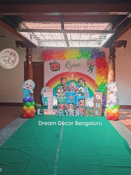 Cocomelon is one of our most requested themes, and we have so much fun with it! This setup for a first birthday features a vibrant rainbow balloon arch, a personalized backdrop with all the favorite characters, and themed props that bring the whole party to life.