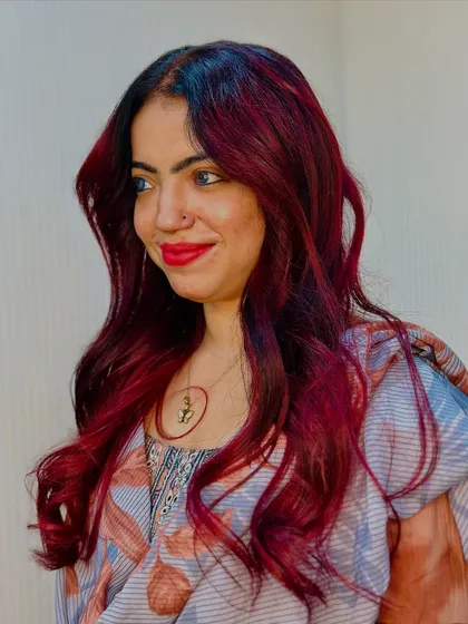 The smile says it all. She's in love with her new cherry red color, and so are we.