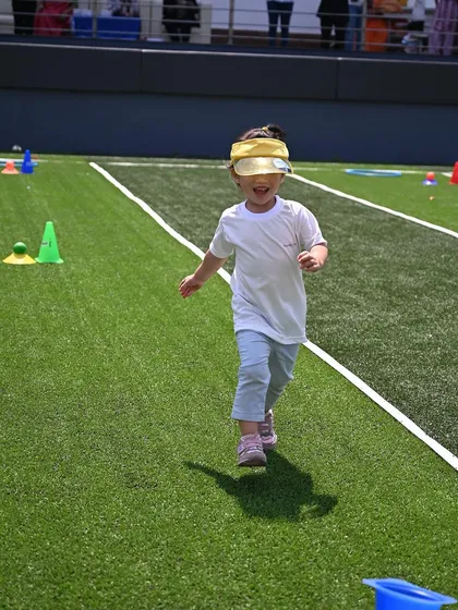 Physical activity is key to a balanced afternoon. This photo from our Annual Sports Meet captures the pure happiness and energy of a child running freely, showcasing our commitment to gross motor skill development in a supportive environment.