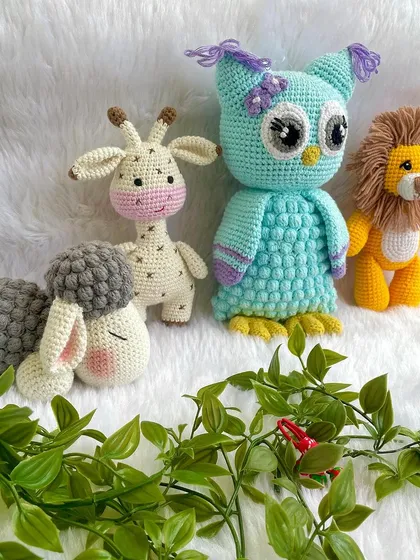 A beautiful collection of baby's first toys, including a gentle giraffe, a wise owl, and a brave lion. All are made with baby-safe materials.