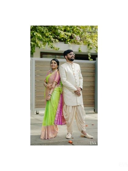 A stylish full-length portrait of the couple in their coordinated engagement outfits.