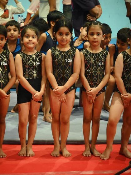 Lined up and ready to perform. This image captures the discipline and focus our gymnasts bring to every competition.