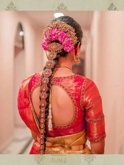 This red bridal blouse features a unique double keyhole back design, outlined with detailed embroidery. It's a perfect example of how I customize traditional elements to create a one-of-a-kind piece.