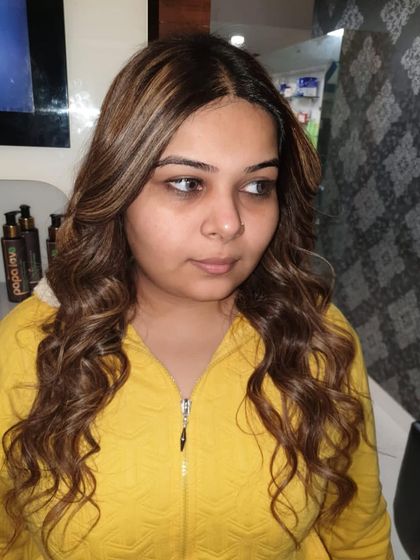 The client is happy with her new look, featuring subtle highlights that add just the right amount of shine and dimension. This is a great option for someone trying highlights for the first time.