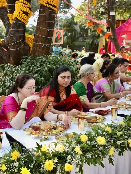 A candid shot of guests enjoying a meal at one of my catered Pangat events. The smiles and shared conversations over delicious food are what make these traditional feasts so special.
