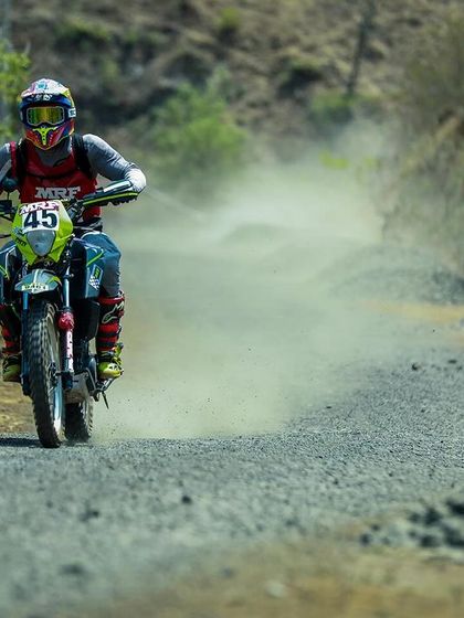 Anish Shetty kicking up dust on his KTM rally bike.