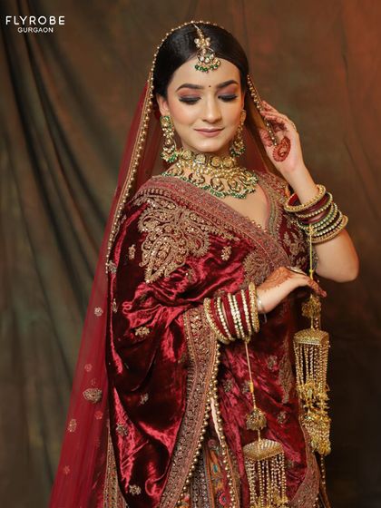 A close-up on the luxurious velvet shawl and the detailed embroidery of the blouse. Every element of this bridal lehenga is crafted to perfection.