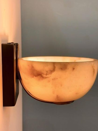 Another angle of the alabaster bowl sconce, showing its simple yet luxurious design. These are perfect for hallways or living rooms.