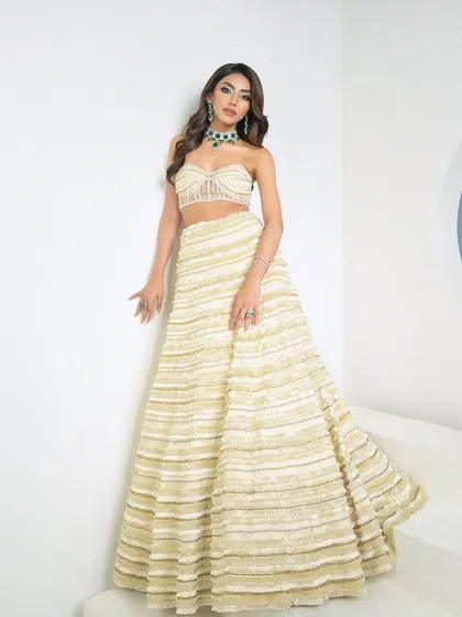 The full view of the ivory crop corset and lehenga, where every delicate stitch tells a story of timeless elegance.