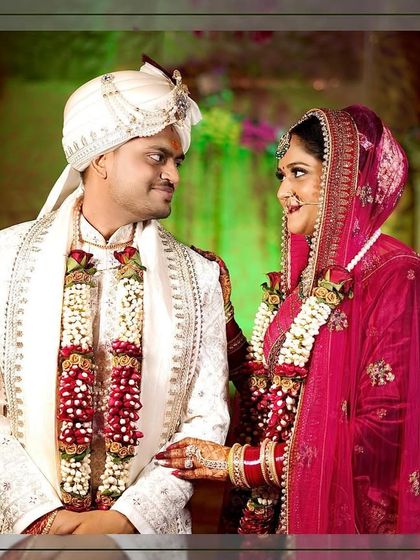 A classic wedding portrait of the couple after the varmala ceremony, looking at each other with love.