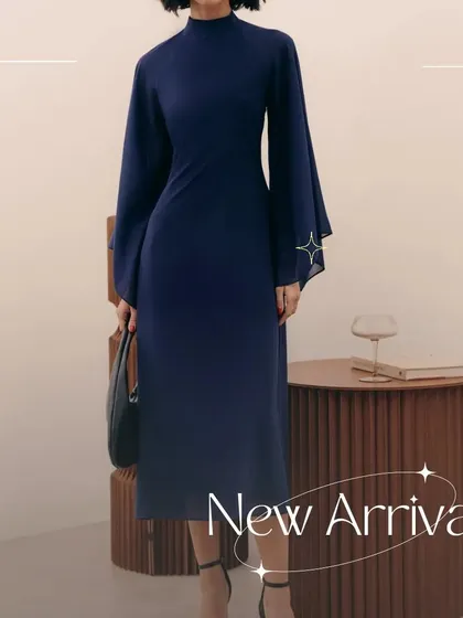 A full-length view of the Armani dress, showing how the flared sleeves and A-line skirt create a balanced and sophisticated silhouette.