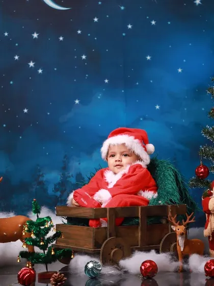 Welcoming the holiday season with a baby's first Christmas photoshoot. This festive Santa setup, complete with a sleigh, reindeer, and a starry night backdrop, is one of my favorite ways to capture holiday magic.