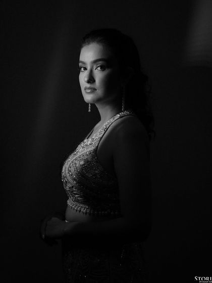 A dramatic black and white profile of the bride, her features beautifully sculpted by the light.