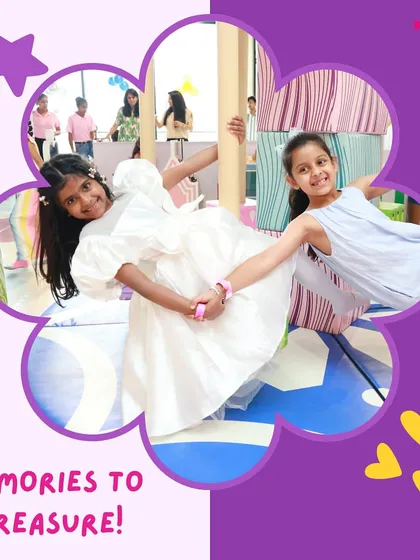 Memories to treasure. Two friends enjoying a spin on our colorful, fruit-themed merry-go-round.