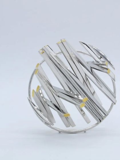 An example of advanced silversmithing, this intricate silver brooch was made by our mentor and serves as inspiration for our workshop participants.