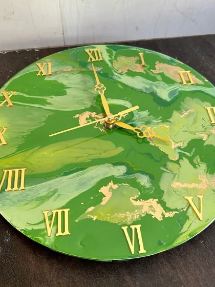 A vibrant green and gold marble resin clock. In my workshop, I'll show you how to mix and pour colors to achieve this fluid, organic look.