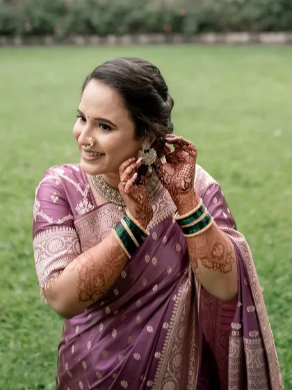 A joyful moment of the bride getting ready. Her makeup is designed to look beautiful from every angle, capturing her happiness.