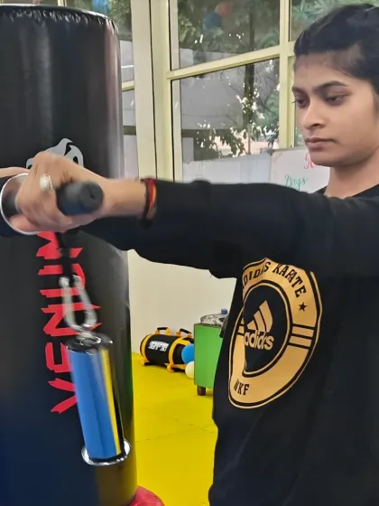 A student building her forearm and grip strength, an essential part of developing powerful blocks and strikes in karate.