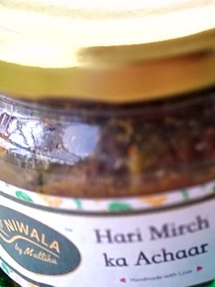 A close-up of the Hari Mirch ka Achaar jar. This spicy and tangy green chilli pickle is handmade with love and is perfect for adding a little excitement to your everyday meals.
