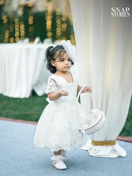 An adorable flower girl in her white lace dress, ready for her walk down the aisle. We capture all the charming details and participants of your wedding day.