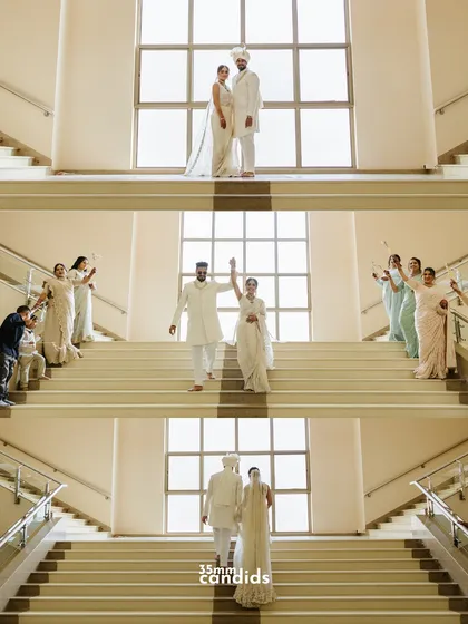 A stunning sequence of the couple's grand exit down a large staircase, surrounded by their loved ones. The symmetry and emotion make this a powerful set of images.