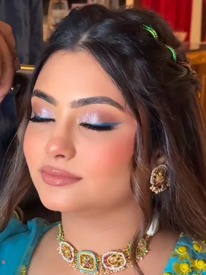 Here is your Haldi carnival look inspiration. We created this stunning look with a focus on the eyes, featuring a graded shimmer and a pop of blue liner.