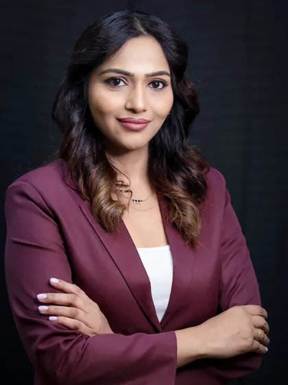 A classic 'boss' pose with arms crossed. This conveys confidence, authority, and professionalism in a business portrait.