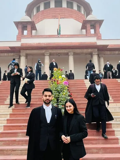 Guiding a young intern on the court grounds. These interactions are crucial for building confidence and providing practical advice on legal practice and courtroom etiquette.