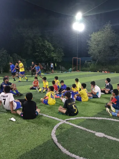 The game isn't just won with your feet, but with your mind. Here, our AIFF licensed coach breaks down tactics with the team under the lights, turning players into thinkers.