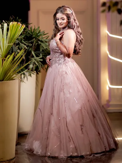 A beautiful solo portrait of the bride-to-be at her engagement, with soft lighting highlighting her gown.