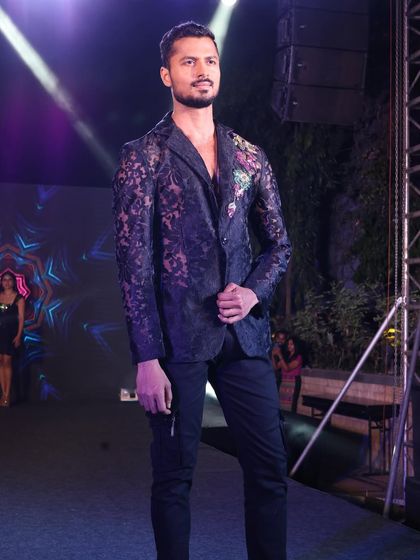 Modeling a sheer lace blazer with floral embroidery for a New Year's Eve event. This look is edgy, festive, and high-fashion.