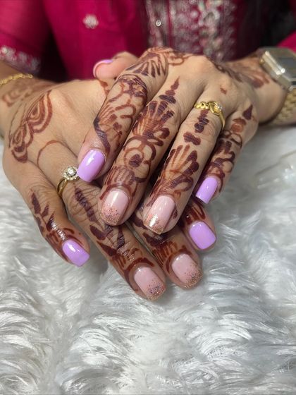 Another view of the lavender and nude glitter gel polish on natural nails. It's a soft and elegant color combination that is perfect for daily wear.