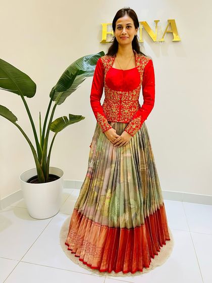 My beautiful client Harshitha in a modern take on the lehenga. I paired a multi-color Kanchi Pattu skirt with a vibrant red, long-sleeve jacket-style blouse featuring intricate embroidery.