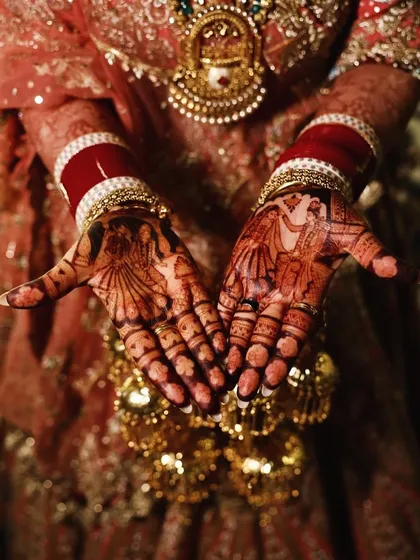 The bride's hands, adorned with her kalire and deeply stained mehandi, ready for her wedding ceremony. A truly beautiful bridal moment.