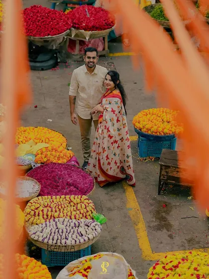An overhead shot capturing the vibrant colors of KR Flower Market in Bangalore. I framed the couple amidst the flower baskets to create a unique and lively portrait that tells a story of love blooming in the city.