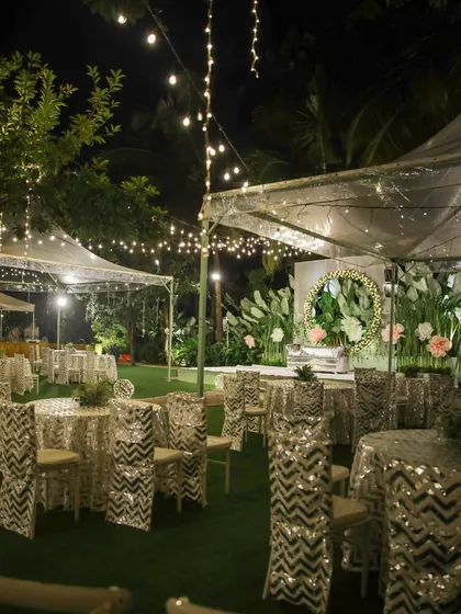 The perfect setting for a pre-wedding cocktail party or sangeet night. The lawn provides ample space for a dance floor, while the surrounding trees, lit with elegant chandeliers and string lights, create a festive and celebratory atmosphere.