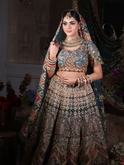 A side profile of the bride, highlighting the hairstyle and the way the dupatta is set.
