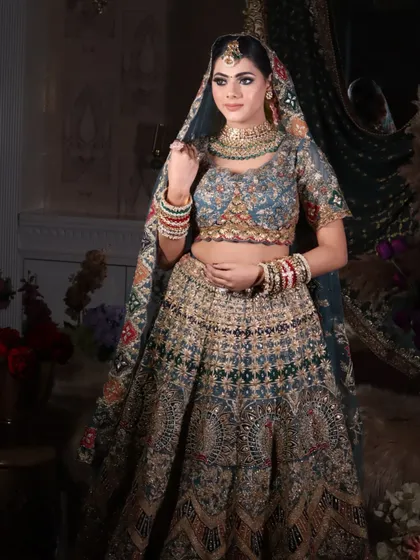 A side profile of the bride, highlighting the hairstyle and the way the dupatta is set.