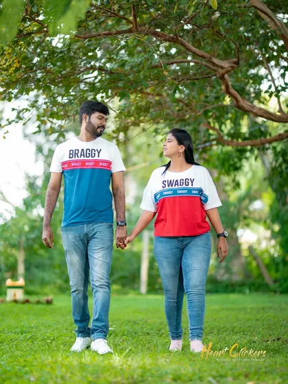 A relaxed and candid moment as a couple in matching t-shirts walks through a park. This shows the simple, joyful, and authentic side of our casual couple photoshoots.