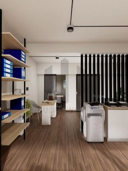 Storage and circulation are key to a functional office. Here, open shelving provides easy access to files, while the clean pathways reduce visual clutter. Every element is designed to support clarity and reduce mental fatigue in a high-focus environment.