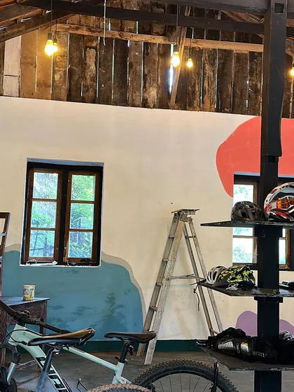 The work-in-progress of an abstract mural at a hostel in Wayanad, Kerala. The design uses simple, flowing shapes and colours to match the rustic, natural vibe of the location.