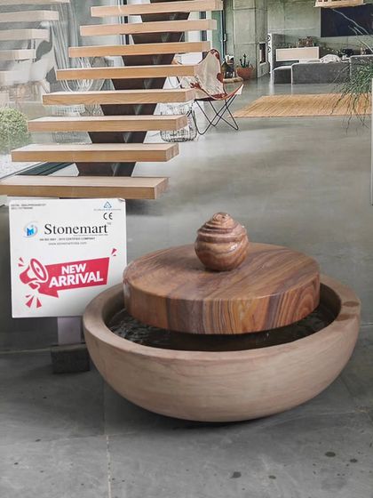 The millstone fountain shown without water, highlighting the beautiful patterns of the Rainbow Sandstone.