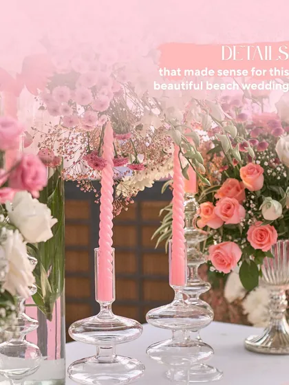 Details that make sense for a beach wedding. The combination of modern glass candle holders, pink spiral candles, and soft florals creates a look that is both chic and romantic.