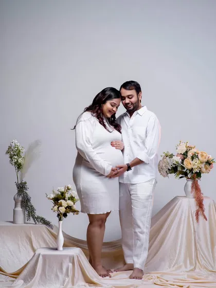 Both parents-to-be gently hold the baby bump, a symbol of their shared love and responsibility. This is a heartwarming portrait of unity and excitement.