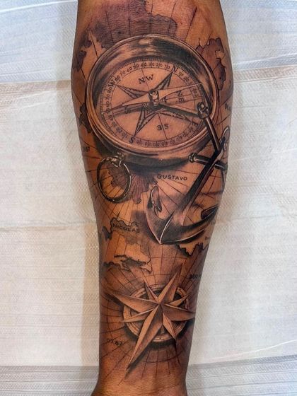 A full forearm sleeve with a travel and adventure theme. This design features a realistic compass, an anchor, and a vintage map, all blended together with smooth shading to create a cohesive and detailed piece.