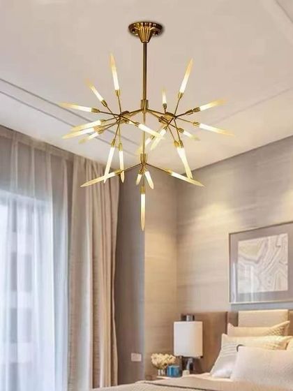 A starburst chandelier with sharp, dagger-like extensions. This design adds a dramatic, mid-century modern flair to this bedroom.